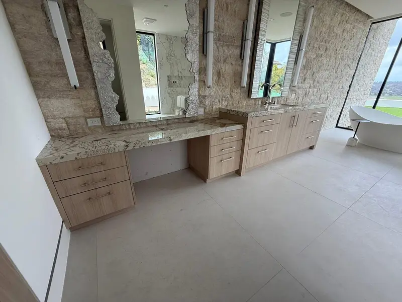 Primary bathroom with stone feature wall