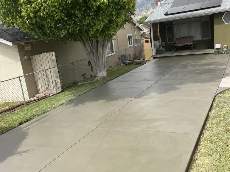 New concrete driveway beside a house