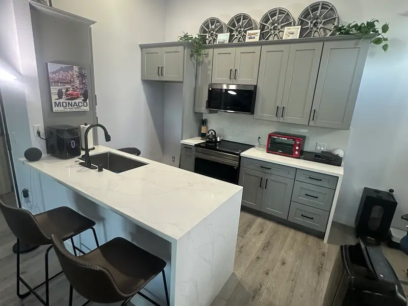 Kitchen remodel with gray cabinets and waterfall island