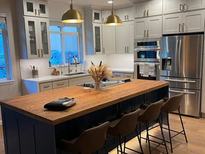 Kitchen with navy island and butcher block top