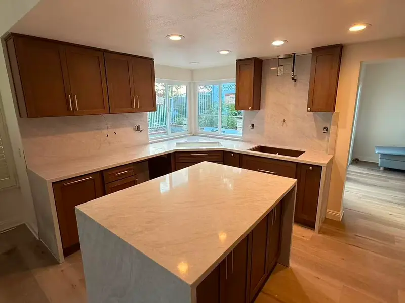 Kitchen remodel with wood cabinets and quartz island