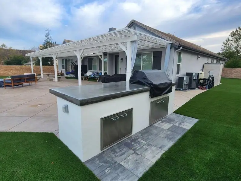 BBQ island beside a pergola patio