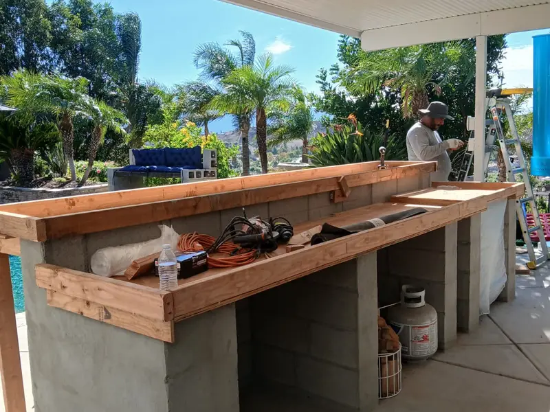 Outdoor bar under a patio cover by the pool